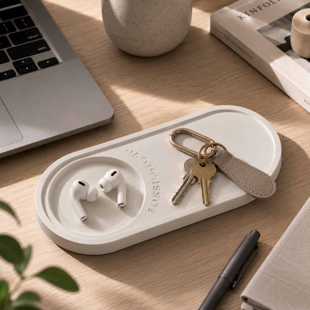 Earbuds and keys on workspace desk with Object Tray