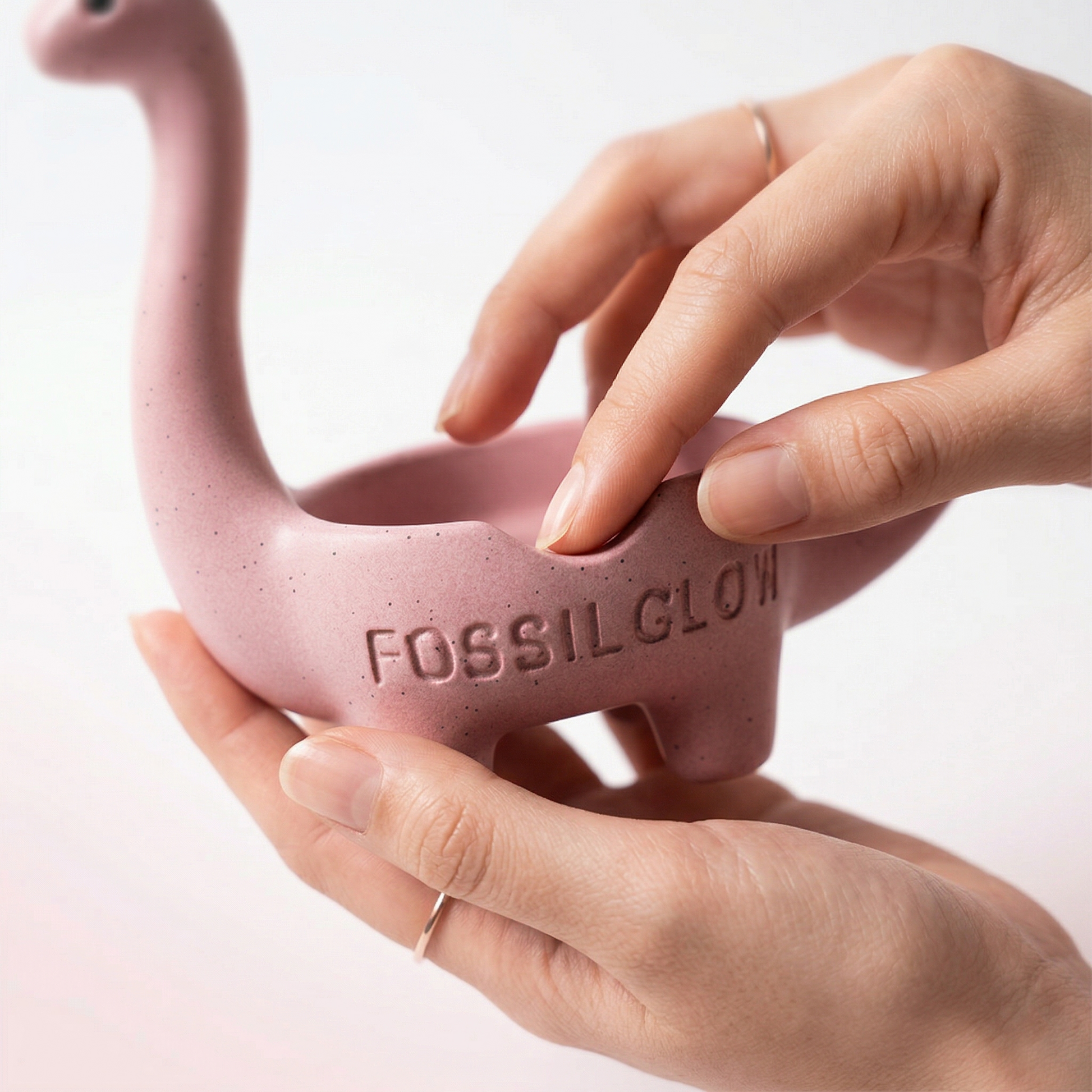 Blush Pink Bronto Jewelry Tray resting in an open hand, indicating its palm-sized scale
